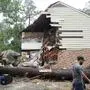 CORRECTION CORRECTS NAME People gather outside a home in the 17400 block of Rustic Canyon Trail where Maria Loredo, 74, died after a tree fell on her second story bedroom during Hurricane Beryl Monday, July 8, 2024, in Houston. (Melissa Phillip/Houston Chronicle via AP)