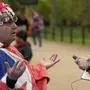 Royal fan John Loughrey speaks to passerby along the King's coronation route at The Mall in London, Tuesday, May 2, 2023. The coronation of King Charles III will takes place at Westminster Abbey on May 6. (AP Photo/Frank Augstein)