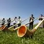 epa00773725 About 50 alphorn players from all parts of Switzerland gathered on Rigi mountain, central part of Switzerland, on Sunday, July 16, 2006, to perform a concert. EPA/URS FLUEELER