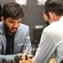 India's grandmaster Gukesh Dommaraju (L) competes against China's chess grandmaster Ding Liren in game 14 of the 2024 FIDE World Championship in Singapore on December 12, 2024. World chess champion Ding Liren, 32, from China, is defending his crown against 18-year-old Indian prodigy Gukesh Dommaraju, who is seeking to make history by becoming the youngest ever undisputed titleholder in the sport. (Photo by Simon Lim / AFP)