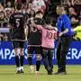 A young fan runs onto the pitch to hug Inter Miami forward Lionel Messi (10) during the second half of the team's MLS soccer match against Sporting Kansas City on Saturday, April 13, 2024, in Kansas City, Mo. (AP Photo/Nick Tre. Smith)