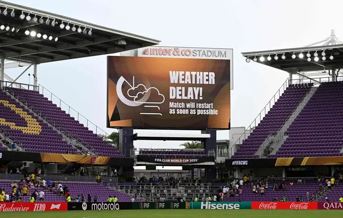 A screen announces a weather delay on the FIFA Club World Cup 2025 Group F football match between South Korea's Ulsan HD and South Africa's Mamelodi Sundowns at the Inter&Co stadium in Orlando on June 17, 2025. (Photo by PATRICIA DE MELO MOREIRA / AFP)