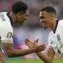 England's Jude Bellingham, left, celebrates with England's Trent Alexander-Arnold after scoring the opening goal during a Group C match between Serbia and England at the Euro 2024 soccer tournament in Gelsenkirchen, Germany, Sunday, June 16, 2024. (AP Photo/Martin Meissner)