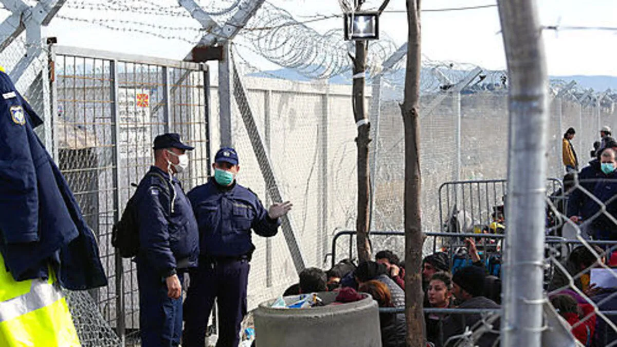 Polizisten und Wartende an der Grenze in Idomeni