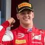 Prema Racing's German driver Mick Schumacher celebrates after winning the Formula Two championship race of the Hungarian Grand Prix at the Hungaroring circuit in Mogyorod near Budapest, Hungary, on August 4, 2019. (Photo by ANDREJ ISAKOVIC / AFP)