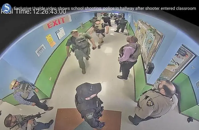 FILE - In this photo from surveillance video provided by the Uvalde Consolidated Independent School District via the Austin American-Statesman, authorities stage in a hallway as they respond to the shooting at Robb Elementary School in Uvalde, Texas, May 24, 2022. The former Uvalde schools police chief and another former officer have been indicted over their role in the slow police response to the 2022 massacre in a Texas elementary school that left 19 children and two teachers dead, according to multiple reports Thursday, June 27, 2024. (Uvalde Consolidated Independent School District/Austin American-Statesman via AP, File)