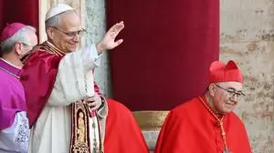 Newly elected Pope Leo XIV, Robert Francis Prevost (C) gestures as he addresses the crowd from the main central loggia balcony of the St Peter's Basilica for the first time, after the cardinals ended the conclave, in The Vatican, on May 8, 2025. Robert Francis Prevost was on Thursday elected the first pope from the United States, the Vatican announced. A moderate who was close to Pope Francis and spent years as a missionary in Peru, he becomes the Catholic Church's 267th pontiff, taking the papal name Leo XIV. (Photo by Andrej ISAKOVIC / AFP)