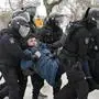Police detain a man as he wanted to lay flowers paying their last respect to Alexei Navalny at the monument, a large boulder from the Solovetsky islands, where the first camp of the Gulag political prison system was established, in St. Petersburg, Russia on Saturday, Feb. 17, 2024. Russian authorities say that Alexei Navalny, the fiercest foe of Russian President Vladimir Putin who crusaded against official corruption and staged massive anti-Kremlin protests, died in prison. He was 47. (AP Photo)