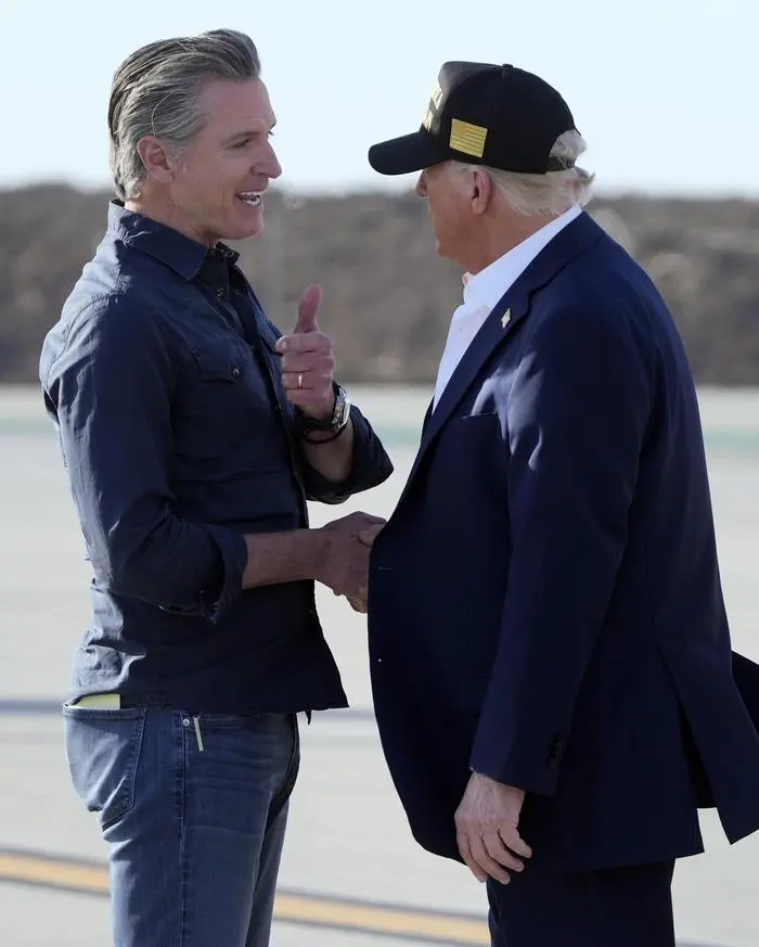 President Donald Trump talks with California Gov. Gavin Newsom after arriving on Air Force One at Los Angeles International Airport in Los Angeles, Friday, Jan. 24, 2025. (AP Photo/Mark Schiefelbein)