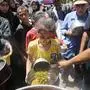 DEIR AL-BALAH, GAZA - MAY 13: Palestinians displaced from Rafah city to Deir al-Balah due to Israeli attacks, wait in long queues to get a bowl of food distributed by charity organizations in Deir al-Balah, Gaza on May 13, 2024. It was stated that hunger awaits 1.7 million Palestinians living in the southern cities as a result of the ground attack launched by the Israeli army on Rafah in southern Gaza and the blocking the humanitarian aids. Due to the Israeli operation that has been going on for days, the Rafah and Kerem Shalom border crossings to the region were completely closed and trucks carrying humanitarian aid were not allowed to enter. Due to the closure of the border gates, displaced Palestinians face the danger of starvation. Ashraf Amra / Anadolu/ABACAPRESS.COM