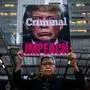 TOPSHOT - Connie Jeung-Mills of San Francisco holds a sign during a demonstration in part of a national impeachment rally, at the Federal Building in San Francisco, California on December 17, 2019. - Protesters around the nation participated in "Nobody is Above the Law" rallies on the eve of a historic Trump impeachment vote in the United States House of Representatives. (Photo by Philip Pacheco / AFP)
