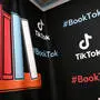 Eine Illustration von bunten Buchrücken und die Schriftzüge „TikTok“ sowie „BookTok“ | Über 60 Millionen Beiträge findet man auf TikTok unter dem Hashtag „#BookTok“
