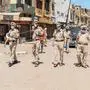 Punjab police personnel wearing facemasks patrol on a deserted street during a government-imposed nationwide lockdown as a preventive measure against the COVID-19 coronavirus, in Amritsar on April 11, 2020. (Photo by NARINDER NANU / AFP)