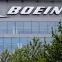 (FILES) In this file photo the Boeing regional headquarters is seen amid the coronavirus pandemic on April 29, 2020, in Arlington, Virginia. - Boeing's medium-term production pipeline remains stable despite the dire state of the airline industry in the wake of coronavirus shutdowns, Boeing Chief Executive Dave Calhoun said in an interview broadcast May 12, 2020. Calhoun was asked on NBC's "Today" show whether he foresaw additional job cuts after the company announced last month it was trimming its headcount by 10 percent. (Photo by Olivier DOULIERY / AFP)