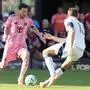 Inter Miami forward Lionel Messi (10) runs with the ball as Vancouver Whitecaps forward Thomas Müller (13) defends during the first half of the MLS Cup final soccer match Saturday, Dec. 6, 2025, in Fort Lauderdale, Fla. (AP Photo/Lynne Sladky)