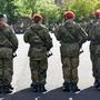 Volkach, Bavaria, Germany - October 1, 2024: A group of soldiers of the German Armed Forces in camouflage uniforms stand in formation armed with rifles at a military roll call *** Eine Gruppe von Soldaten der Deutschen Bundeswehr in Tarnuniformen stehen in Formation mit Gewehr Bewaffnet bei einem Militär Appell