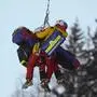 Austria's Nadine Fest is carried with a helicopter after crashing during an alpine ski, women's World Cup super-G race, in Altenmarkt-Zauchensee, Austria, Friday, Jan. 12, 2024. (AP Photo/Giovanni Auletta)
