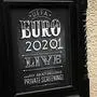 A sign advertising the now-postponed Euro 2020 football tournament is pictured outside a closed-down pub in York in northern England on March 30, 2020, as life in Britain continues during the nationwide lockdown to combat the novel coronavirus pandemic. - Life in locked-down Britain may not return to normal for six months or longer as it battles the coronavirus outbreak, a top health official warned on Sunday, as the death toll reached passed 1,200. Euro 2020, scheduled to take place in 12 European cities from June 12 to July 12 has been put off until 2021. "Although it will provisionally take place from 11 June - 11 July 2021, #EURO2020 will still be known as UEFA EURO 2020," UEFA said on Twitter. (Photo by Oli SCARFF / AFP)