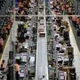 (FILES) In this file photo taken on November 08, 2018 shows employees working at the distribution center of US online retail giant Amazon in Dortmund, Germany. - Hundreds of Amazon workers in Germany walked off the job as the US online retailer kicked off its "Black Friday" sales bonanza, escalating a long-simmering battle for better pay and working conditions. (Photo by Ina Fassbender / dpa / AFP) / Germany OUT