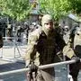 NATO-led Kosovo Force (KFOR) soldiers, wearing full riot gear, place metal fences around the municipal building in Zvecan, northern Kosovo on May 30, 2023, a day following clashes with Serb protesters demanding the removal of recently elected Albanian mayors. The situation in northern Kosovo remained tense on May 30, 2023, as ethnic Serbs continued to gather in front of a town hall in Zvecan after violent clashes with NATO-led peacekeepers left 30 soldiers injured. (Photo by STRINGER / AFP)