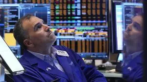 Trader Christopher Lagana is reflected in one of his monitors as he works on the floor of the New York Stock Exchange, Thursday, Nov. 7, 2024. (AP Photo/Richard Drew)