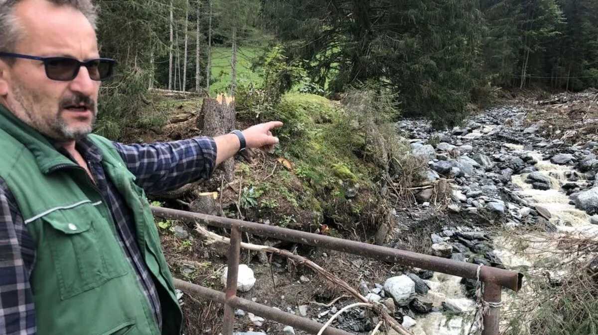 Reinhard Dullnigg zeigt auf den Bach, der zweimal sein Anwesen verwüstet hat. Eine Verbauung ist an dieser Stelle unwahrscheinlich, die Gefahr bleibt