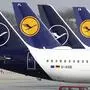 In this Thursday, March 26, 2020 file photo German Lufthansa planes sit parked in a line at the airport in Munich, Germany. Due to the coronavirus Lufthansa had to cancel most of its flights. (AP Photo/Matthias Schrader)