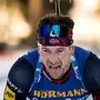 Third placed Norway's Sturla Holm Laegreid crosses the finish line of the men's 12,5 km pursuit event of the IBU Biathlon World Cup in Lenzerheide on December 16, 2023. (Photo by Fabrice COFFRINI / AFP)