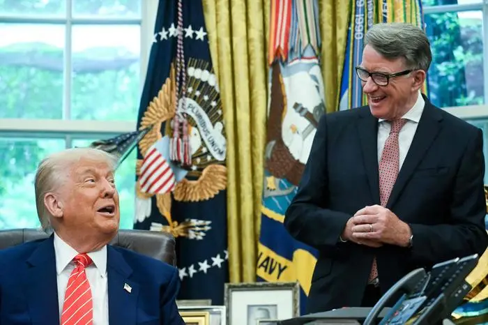 US President Donald Trump makes a trade announcement as British ambassador to the United States Peter Mandelson (R), looks on in the Oval Office of the White House in Washington, DC, on May 8, 2025. US President Donald Trump on announced a 