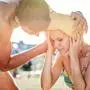 Man helping woman in bikini with heatstroke, summer heat Young man helping woman in bikini with heatstroke, summer heat, sunny day model released Copyright: xx Couple at swimming pool_098