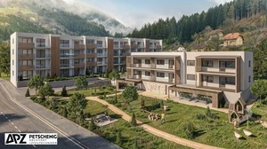 Man sieht Wohngebäude und einen Spielplatz davor