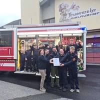 Große Freude über den Bezirkssieg: Kleine Zeitung-Teamleiterin Bettina Friedl überreicht die Urkunde an Tobias Neuper, Markus Klanschek, Markus Hobel-Podrecnik und Alexander Marchsteiner von der FF Miklauzhof. Im Hintergrund jubelt ein Teil der Jugendfeuerwehr-Truppe am Fahrzeug