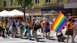 Eine Gruppe junger Menschen mit einer großen bunten Fahne