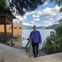 Eine Frau steht auf einer Holzstiege vor einem See