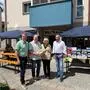 Vier Personen stehen vor einem Geschäft