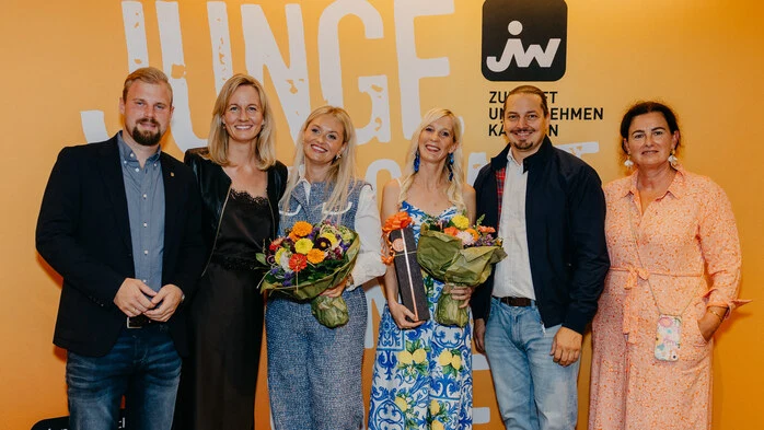 ÖVP-Stadtrat Philipp Subosits, Carmen Goby, Anamaria Gassinger, Stefanie Taupe, Walter Sabitzer, Doris Weiß stehen vor eine Junge Wirtschaft-Transparent. Gassinger und Taupe halten Blumensträuße in den Händen