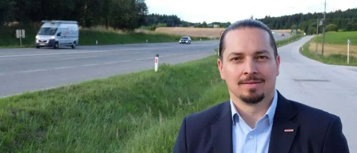 Ein Mann steht an einer Straße.