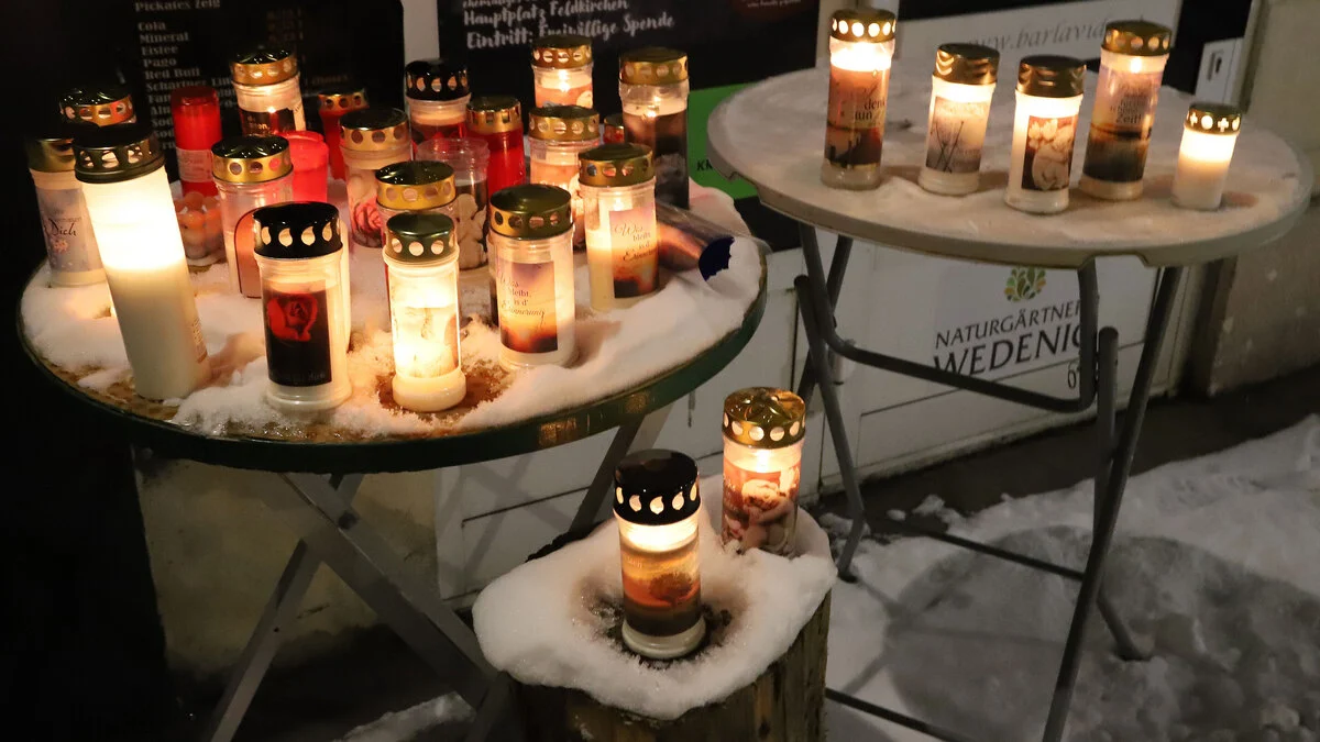 Zwei Stehtische vor einem Lokal mit mehreren Kerzen  | Vor der Rockfiliale wurden, seit dem Todestag von Sobian, mehrere Kerzen angezündet 