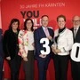 Vier Männer und drei Frauen posieren vor einer Fotowand an der FH Kärnten in Villach | Siegfried Spanz, Petra Oberrauner, Sara Schaar, Martin Waiguny, Sabine Herlitschka, Karl Cernic und Peter Granig