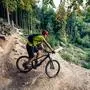 Mountain biker riding on bike in autumn inspirational mountains landscape. Man cycling MTB on enduro trail track. Sport fitness motivation and inspiration.