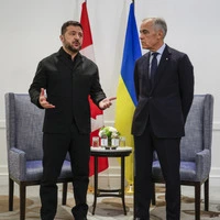 Canadian Prime Minister Mark Carney (R) listens to Ukrainian President Volodymyr Zelensky as they meet in Calgary, Alberta, on September 10, 2026. Canada is providing Ukraine additional support in air defense, Ukrainian President Volodymyr Zelensky said during a visit for talks with Prime Minister Mark Carney. Ukraine has stressed its urgent need for improved aerial defense in response to increased Russian ballistic missile strikes. (Photo by Jeff McIntosh / POOL / AFP)