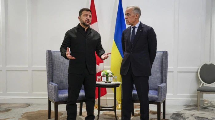 Canadian Prime Minister Mark Carney (R) listens to Ukrainian President Volodymyr Zelensky as they meet in Calgary, Alberta, on September 10, 2026. Canada is providing Ukraine additional support in air defense, Ukrainian President Volodymyr Zelensky said during a visit for talks with Prime Minister Mark Carney. Ukraine has stressed its urgent need for improved aerial defense in response to increased Russian ballistic missile strikes. (Photo by Jeff McIntosh / POOL / AFP)