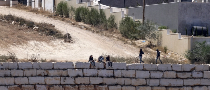 Israeli settlers gather in front of Palestinian houses in the village of Qusra, south of Nablus, in the occupied West Bank, on August 13, 2026. Israel has occupied the West Bank since 1967. More than 500,000 Israelis live in settlements in the territory, which are illegal under international law, among some three million Palestinians. Violence against Palestinians by Israeli settlers has increased dramatically since the October 7, 2023 attack on Israel by Hamas from the Gaza Strip. (Photo by Zain JAAFAR / AFP)
