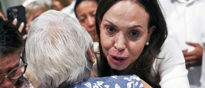 Venezuelan opposition leader Maria Corina Machado embraces a woman as she leaves after a mass at the National Basilica Santa Maria la Antigua in Panama City on July 5, 2026. (Photo by ARNULFO FRANCO / AFP)