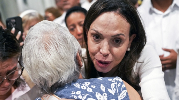 Venezuelan opposition leader Maria Corina Machado embraces a woman as she leaves after a mass at the National Basilica Santa Maria la Antigua in Panama City on July 5, 2026. (Photo by ARNULFO FRANCO / AFP)