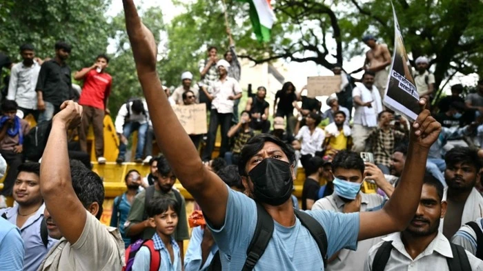 TOPSHOT - A Cockroach Janta Party (CJP) supporter shouts slogans at Jantar Mantar in New Delhi on July 23, 2026 during the ongoing protest to demand the resignation of India's Education Minister Dharmendra Pradhan over alleged NEET exam irregularities. Indian Prime Minister Narendra Modi on July 23 vowed "stringent punishment" for those involved in exam fraud that has fuelled student anger, in his first direct comments tied to major protests challenging his government. (Photo by Sajjad HUSSAIN / AFP)