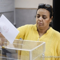 A woman casts her ballot as she votes during Morocco's legislative elections at a polling station inside a school at the Udayas neighborhood in Rabat on September 23, 2026. Moroccans headed to the polls on September 23 to elect a new parliament, with voters focused on the cost of living, employment and inequality while parties stand challenged by distrust. Polling stations opened at 08:00 am (0800 GMT) and were set to close at 07:00 pm, with preliminary results to be announced later at night. (Photo by Abdel Majid BZIOUAT / AFP)