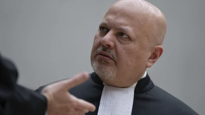 Chief Prosecutor Karim Khan talks prior to the first appearance of former Philippine President Rodrigo Duterte before the International Criminal Court (ICC) on charge of crimes against humanity over his deadly crackdown on narcotics, in The Hague on March 14, 2025. The 79-year-old, the first ex-Asian head of state to face charges at the ICC, followed by videolink during a short hearing to inform him of the crimes he is alleged to have committed, as well as his rights as a defendant. Duterte stands accused of the crime against humanity of murder over his years-long campaign against drug users and dealers that rights groups said killed thousands. (Photo by Peter Dejong / POOL / AFP)