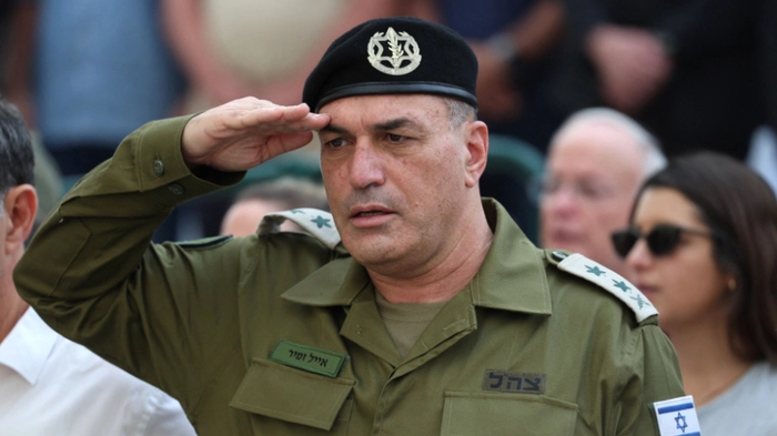 Israel's military chief Lieutenant General Eyal Zamir salutes during the funeral of Lieutenant Hadar Goldin who was killed during the six-week 2014 war in Gaza, at a military cemetery in Kfar Saba on November 11, 2025. Hundreds of Israelis gathered on November 11 in the central town of Kfar Saba to lay to rest army officer Hadar Goldin, whose remains were returned by Hamas after being held in Gaza for more than a decade. Israel received Goldin's remains as part of an ongoing Gaza ceasefire deal brokered by US President Donald Trump. (Photo by Abir SULTAN / POOL / AFP)