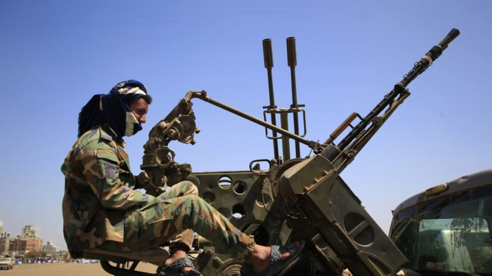 A Yemeni soldier keeps vigil from a vehicle as supporters of the Iran-backed Houthi movement, rally in solidarity with Iran and Lebanon, in Sanaa on April 8, 2026, following the announcement of a ceasefire in the Middle East war. The United States and Iran agreed to a two-week ceasefire barely an hour before the US president's April 8 deadline to obliterate the country, triggering global relief alongside apprehension. (Photo by Mohammed HUWAIS / AFP)